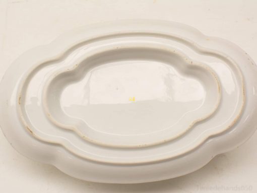 Elegant vintage white porcelain serving platter, ideal for any dining occasion and showcasing unique character.