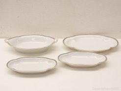 Elegant porcelain serving dishes with gold trim, perfect for formal dining occasions.