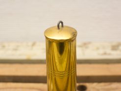 Vintage brass spice container with elegant design and decorative lines, perfect for nostalgic kitchens.