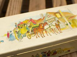 Vintage tin box featuring a charming horse-drawn carriage and nostalgic transportation scene.