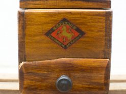 Antique wooden box with guarantee logo and unique mythical design for collectors and vintage enthusiasts.