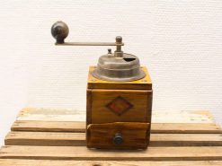 Vintage wooden coffee grinder with metal mechanism, perfect for nostalgic coffee enthusiasts.