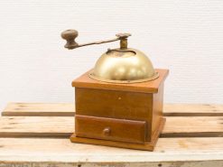 Vintage wooden coffee grinder with brass lid, perfect for traditional coffee lovers.