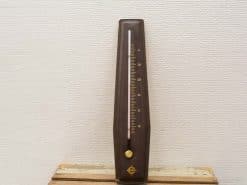 Elegant vintage wooden metronome with silver pendulum, perfect for musicians and collectors.