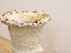 Antique floral planter with rustic charm and intricate details, perfect for adding character.