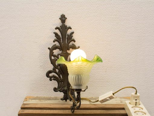 Charming vintage wall lamp with green and white glass shade for a cozy atmosphere.