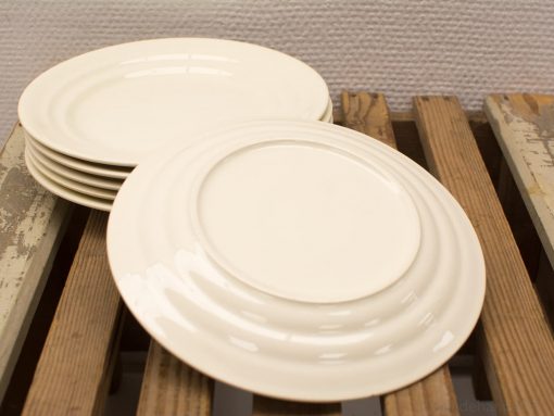 Timeless white plates on rustic wood, perfect for any dining occasion or decor.