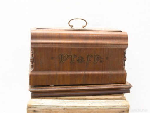 Elegant vintage Pfaff wooden sewing machine case, showcasing artistry and functionality. Perfect for collectors.