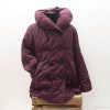 Chic burgundy quilted coat with hood, oversized fit, large buttons, and deep pockets for winter warmth.