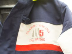 Nautical-inspired classic sailing jacket in navy with white and red accents, perfect for outdoor enthusiasts.