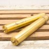 Vintage brass tubes on rustic wood, showcasing elegance and character. Perfect for collectors.