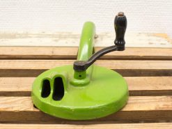 Vintage green hand-crank kitchen tool, perfect for food processing and retro collectors.