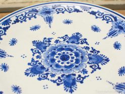 Hand-painted blue and white ceramic bowl with floral design, ideal for home decor or collectors.