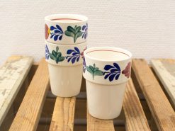 Charming vintage ceramic cups with vibrant floral patterns, perfect for any occasion.