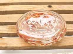 Elegant glass dish with vibrant red and white design, perfect for decor or everyday use.