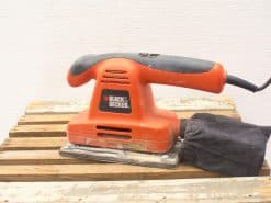 Used BLACK+DECKER electric sander with dust bag, ideal for DIY and professional projects.