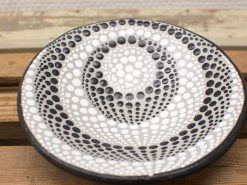 Elegant black and white geometric dot plate, ideal for decor or as a centerpiece.