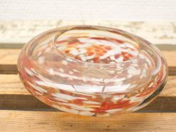 Elegant glass dish with vibrant red and white swirls, perfect for decorative or practical use.