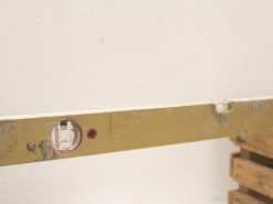 Vintage wooden level with green and red indicators for precise leveling in construction.