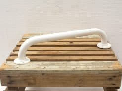 Rustic wooden platform with white grab bar for safety in bathrooms or workshops.