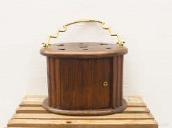 Antique wooden storage container with elegant brass handle and ventilated lid for plants or items.