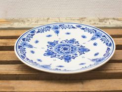 Elegant blue and white porcelain plate with floral motif, perfect for decoration or special occasions.