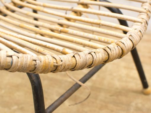 Elegant vintage bamboo chair with black metal frame, blending organic design and industrial aesthetics.