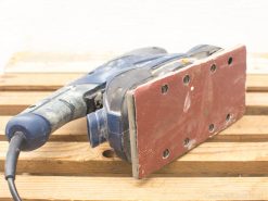 Vintage blue power sander, perfect for woodworking with ergonomic design and efficient dust extraction.