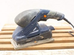 Used electric power sander for woodworking on vintage wood pallets, ideal for craftsman projects.