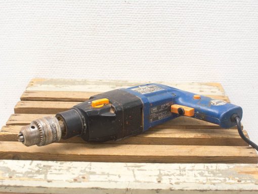 Used AEG power drill on rustic wood, perfect for creative DIY projects and repairs.