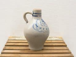 Elegant gray ceramic jug with blue floral design, perfect for décor or functional use.