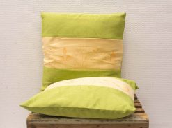 Elegant green and cream decorative cushions for a cozy, modern interior design.