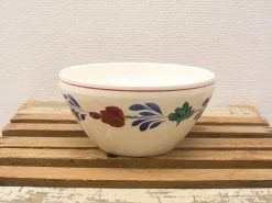 Elegant ceramic flower bowl with a glossy finish on a rustic wooden surface.