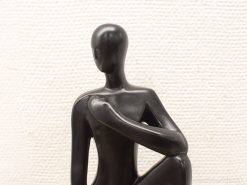 Elegant black sculpture of contemplation, inviting introspection and reflection in any space.