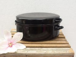 Elegant black casserole dish with lid and magnolia flower, perfect for cooking and serving.