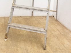 Worn gray step ladder showcasing character, history, and practical design for home projects.