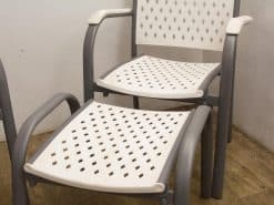 Stylish gray and white perforated chairs, perfect for indoor or outdoor relaxation and easy storage.