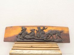 Wooden plaque depicting a shepherd with dogs, celebrating pastoral life and natures beauty.