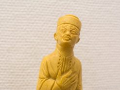 Detailed wooden sculpture of a speaking man showcasing cultural heritage and expressive artistry.