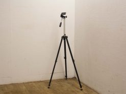 Classic vintage tripod with adjustable mount for photographers and videographers, ensuring stability and creativity.