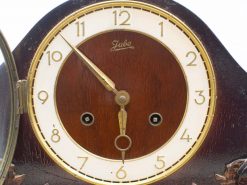 Elegant vintage wall clock with gold rim and wooden finish, perfect for classic decor.