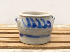 Handcrafted gray ceramic pot with vibrant blue patterns, perfect for decorative and functional use.