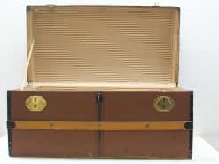 Classic vintage trunk with brass accents, elegant interior, and secure locking mechanisms for stylish storage.