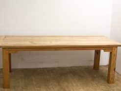 Rustic wooden dining table, perfect for cozy gatherings and versatile in any interior style.