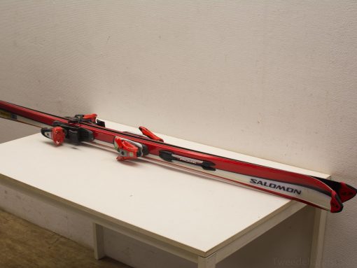 Vibrant red Salomon skis with modern bindings, perfect for adventure on snowy slopes.