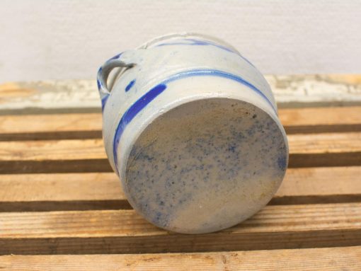 Vintage ceramic jug with blue patterns, ideal for decor or functional use.