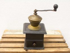 Antique wooden coffee grinder with brass accents, showcasing vintage charm and craftsmanship.