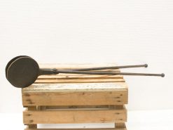 Antique metal tongs on rustic wooden pallet, perfect for vintage cooking enthusiasts.