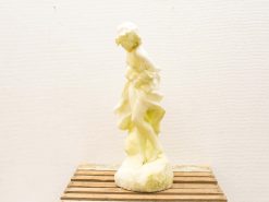 Elegant marble statue of a young woman in flowing drapery, showcasing dynamic movement.