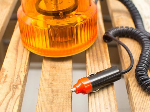 Bright orange emergency light with coiled power cord, ideal for safety in urgent situations.